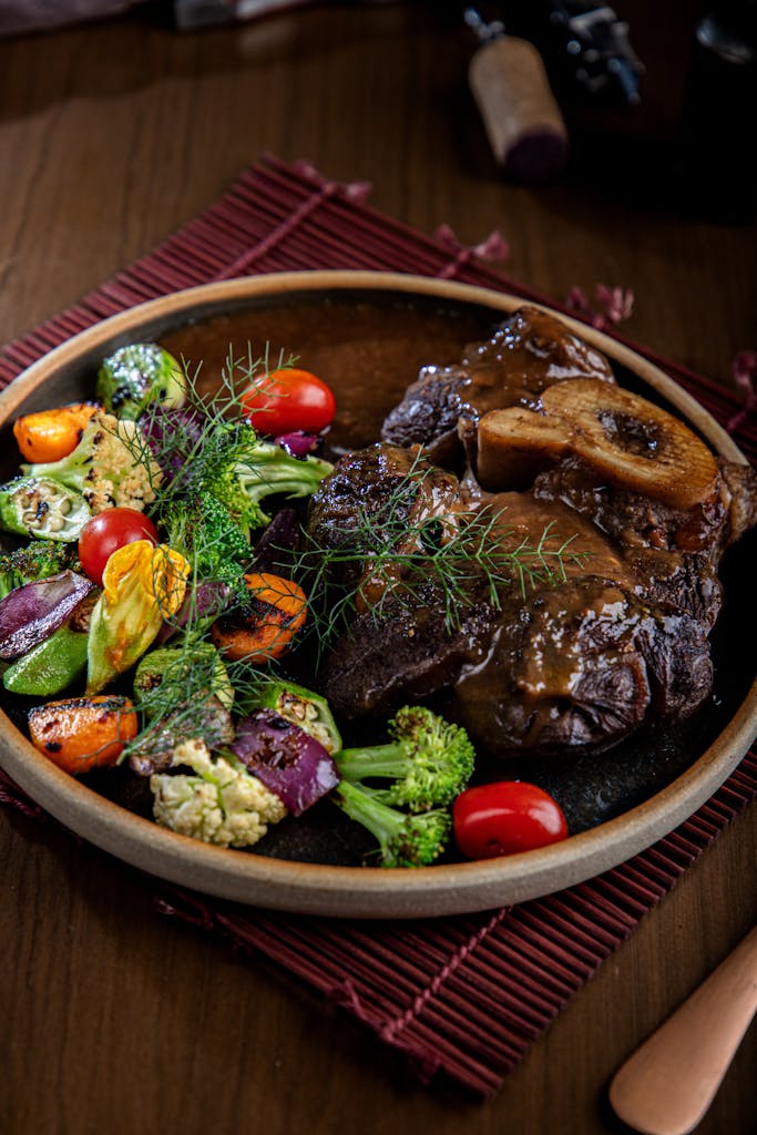 Succulent Osso Buco served with vibrant roasted vegetables captures a gourmet experience.